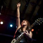 Goodnight Lane guitarist and singer Janel Duarte waves to the crowd after a song in her band's set during the Rock Camp USA concert at Antone's on Saturday, July 24, 2010.