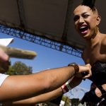 Ongina reacts as a man stuffs money down her bra during a drag performance of Lady Gaga's "Bad Romance" on Sunday, Sept. 12, 2010, at the Peoria Pride Festival on the Riverfront.