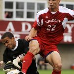 Bradley's Christian Meza (22) plays the ball into the box as SMU keeper Craig Hill, left, tries to stop the advance during a game on Saturday, Sept. 19, 2010, at Shea Stadium in Peoria. Meza advanced the ball past the keeper and scored Bradley's only goal on the play as the Braves lost 3-1.