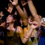 Fans react after Weezer frontman Rivers Cuomo jumped off stage and hoped onto a barricade in front of the crowd while singing "Troublemaker" during a performance on Saturday, Sept. 25, 2010, at Bradley University.