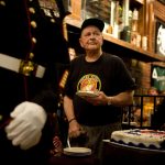 Karl Schmidt, a World War II veteran and Marine who served in the Battle of Iwo Jima in 1945, holds a piece of cake as one of the oldest Marines in attendance at a Semper Fi Fish Fry on Sunday, Nov. 7, 2010, at Kelleher's Irish Pub. The event featured a formal Marine cake cutting ceremony in which guests of honor, the oldest Marine and youngest Marine receive pieces of cake cut by a Mameluke sword.