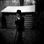 Tim Varvil, the president of the Central Illinois Living Historians, rests with his rifle on Saturday, Nov. 20, 2010, at Sommer Park. Re-enactors created a Civil War winter encampment to show how soldiers lived through the winter months when fighting generally stopped in the war.