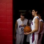 Peoria Heights' Zach Wilson (54) peeks out at the court as teammate Jon Lowry, right, holds the ball ready to lead the team out of the locker room before a game against Beardstown on Friday, Dec. 3, 2010, in Peoria Heights.