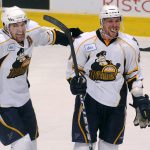 Peoria Rivermen right wing Graham Mink, left, celebrates with teammate Peoria Rivermen defender Nathan Oystrick after Oystrick scored a goal late in the third period of a game against Milwaukee on Sunday, Dec. 5, 2010, at Carver Arena.