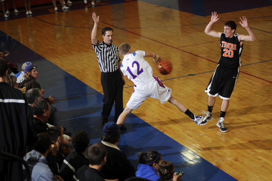 Peoria Heights' Zach Jacobs (12) tries to save the ball by bouncing it off of Beardstown's Jared Rohn (20) during a game on Friday, Dec. 3, 2010, in Peoria Heights.