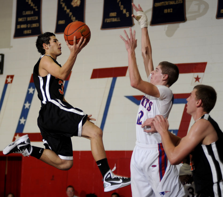 Beardstown's Melvin Coney (3) soars to the basket as Peoria Heights' Zach Jacobs during a game on Friday, Dec. 3, 2010, in Peoria Heights.