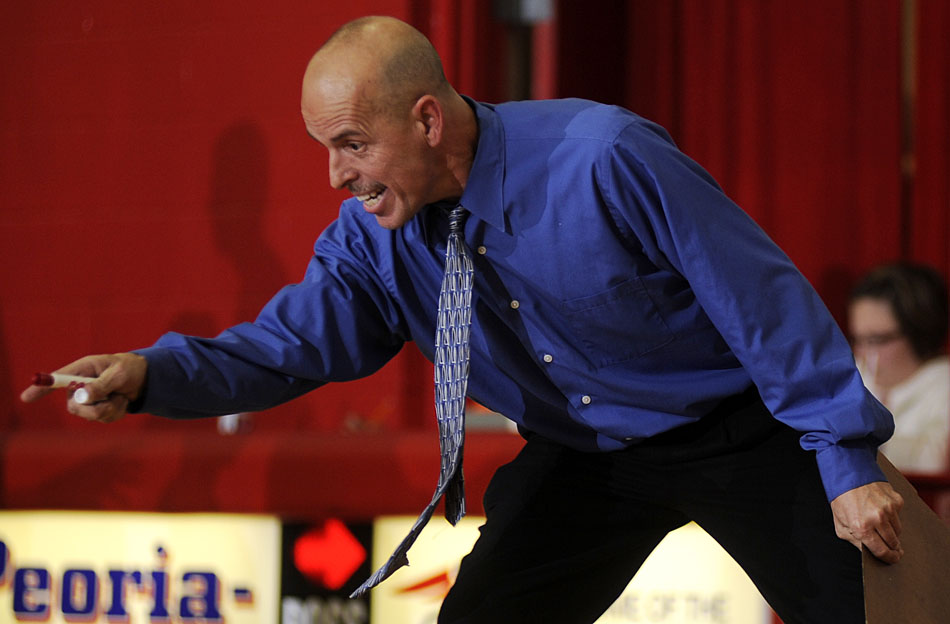 Peoria Heights coach Mike Persich yells to a player during a break in action in a game on Friday, Dec. 3, 2010, in Peoria Heights.