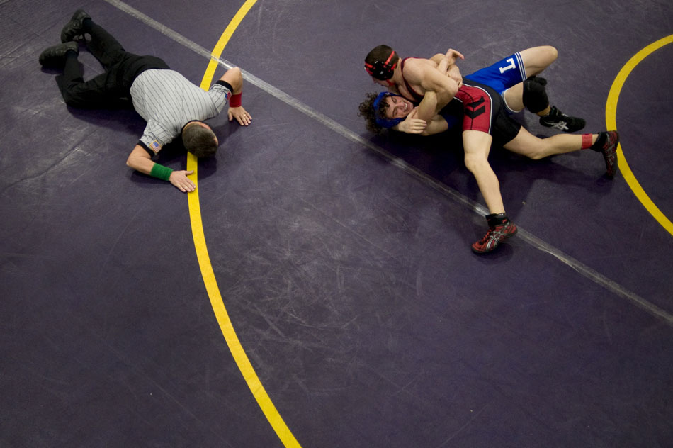 The referee watches closely as a Limestone wrestler attempts to pin his Springfield counterpart during a tournament on Saturday, Dec. 4, 2010, at Notre Dame High School.