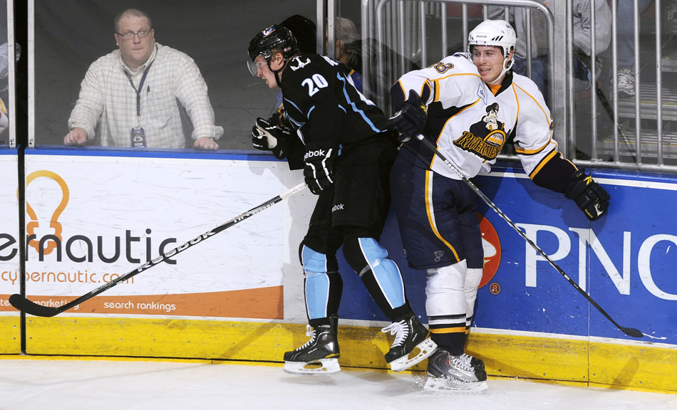 Peoria Rivermen defender Ian Cole reacts as he collides into the boards with Milwaukee Admirals right wing Mike Bartlett during a game on Friday, Dec. 31, 2010, at Carver Arena.