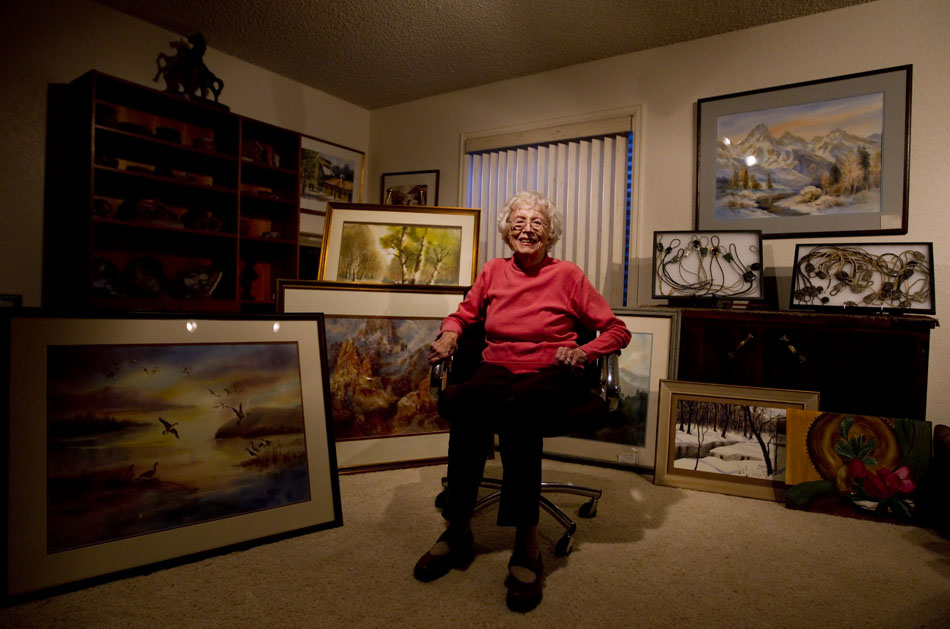 Painter Carleen Williams, age 97, poses with a small portion of her paintings on Tuesday, Jan. 11, 2011, in her Cheyenne home. Williams, a native of Lincoln, Neb., started painting when she was bed stricken with asthma as a small child. From her bed, she started sketching people. "Each day when the doctor would come, I'd have a new picture," she said.