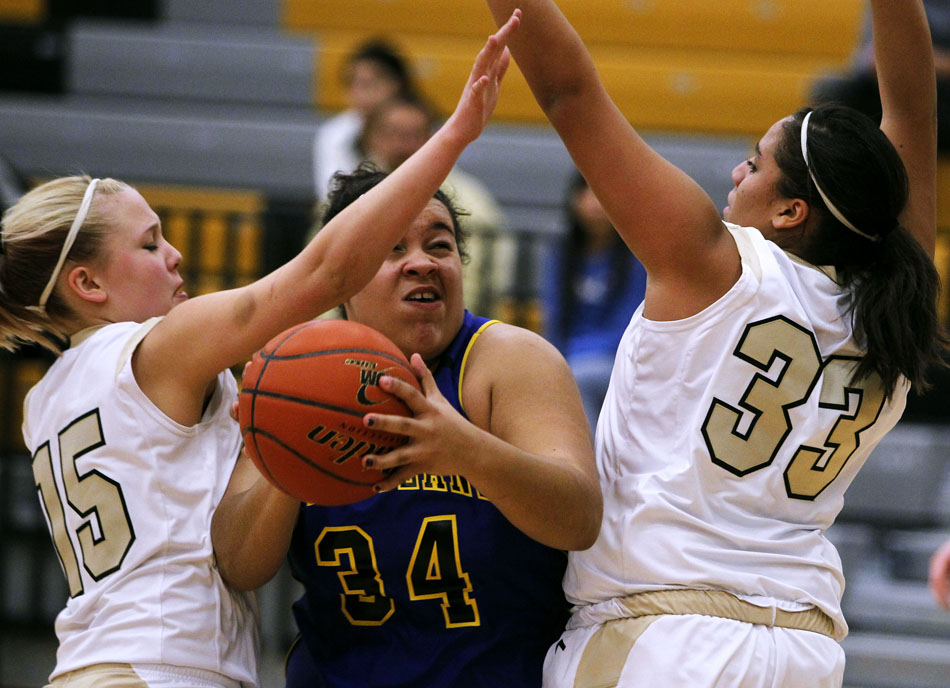 Wheatland's Breann Jackson (34) looks to put up a shot between South's Shyloh Myers (15) and Jasmin Waters (33) during a game on Tuesday, Jan. 18, 2011, at South.