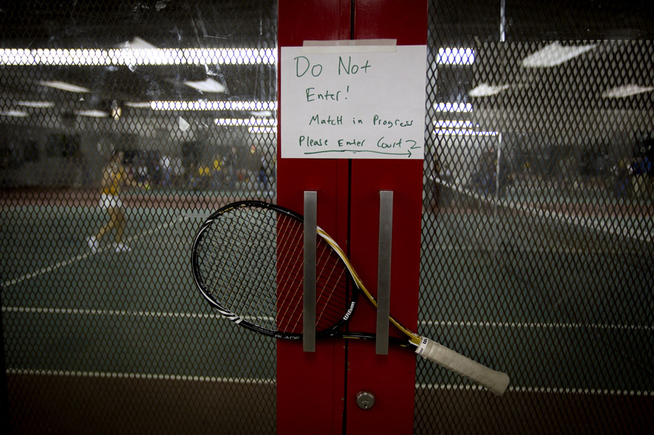A tennis racket bars the door leading to a court as the University of Wyoming takes on Mesa State on Friday, Jan. 21, 2011, at the Frontier Park Tennis Complex in Cheyenne.