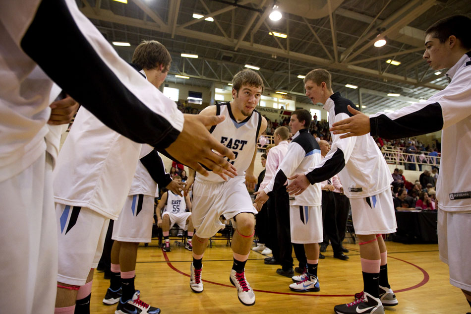 Cheyenne East's Trevon Hinker (22) runs onto the court as he's introduced as a starter for a game against Central on Saturday, Jan. 22, 2011, at Storey Gym.