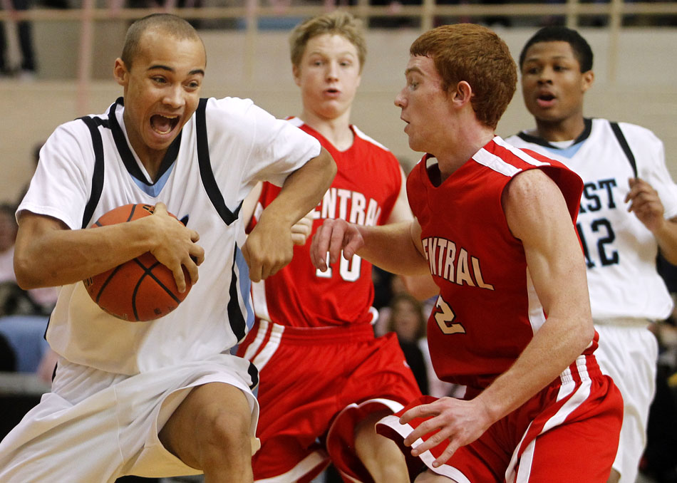 Cheyenne East's Derek Graves, left, reacts as he drives to the basket in front of Central's Josh Borm (2) during a game on Saturday, Jan. 22, 2011, at Storey Gym. East won 50-33.
