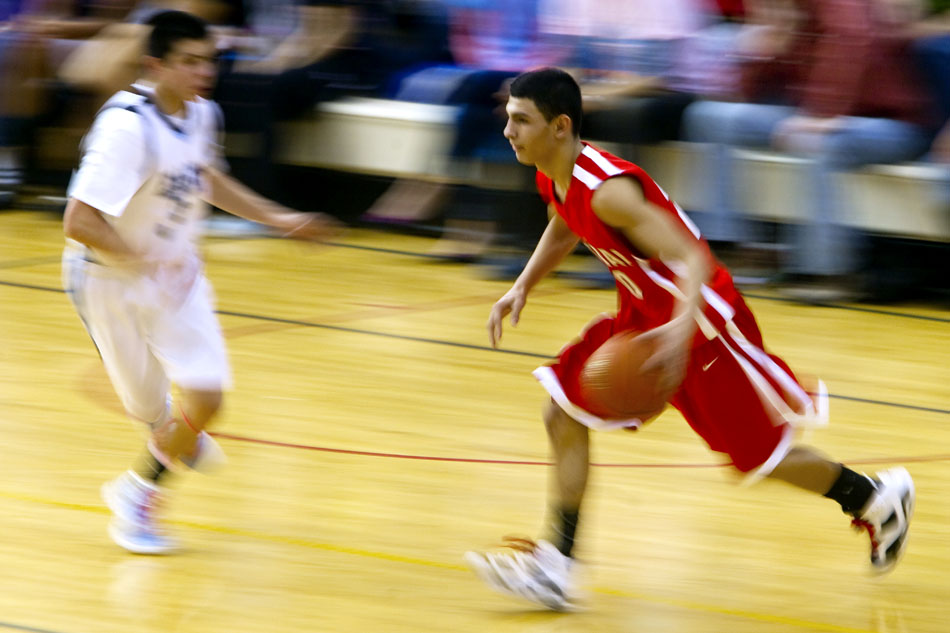 Cheyenne Central's Matt Munoz, right, drives to the basket in front of East's Cameron Jaure during a game on Saturday, Jan. 22, 2011, at Storey Gym. East won 50-33.