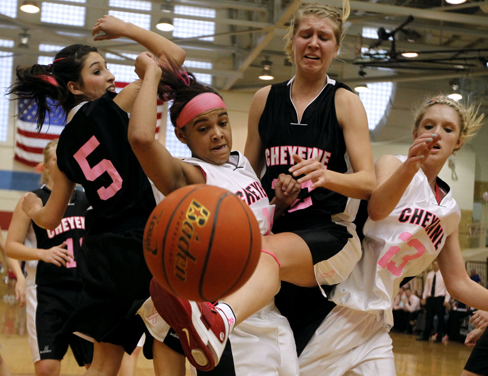 Cheyenne East's Lexi Hawkins, second from right, looses the handle on a rebound in front of Central's Mo Chavez (5) and Christie Schiel (22) and East's Meghan Sipe (23) during the East-Central rivalry game on Saturday, Jan. 22, 2011, at Storey Gym.
