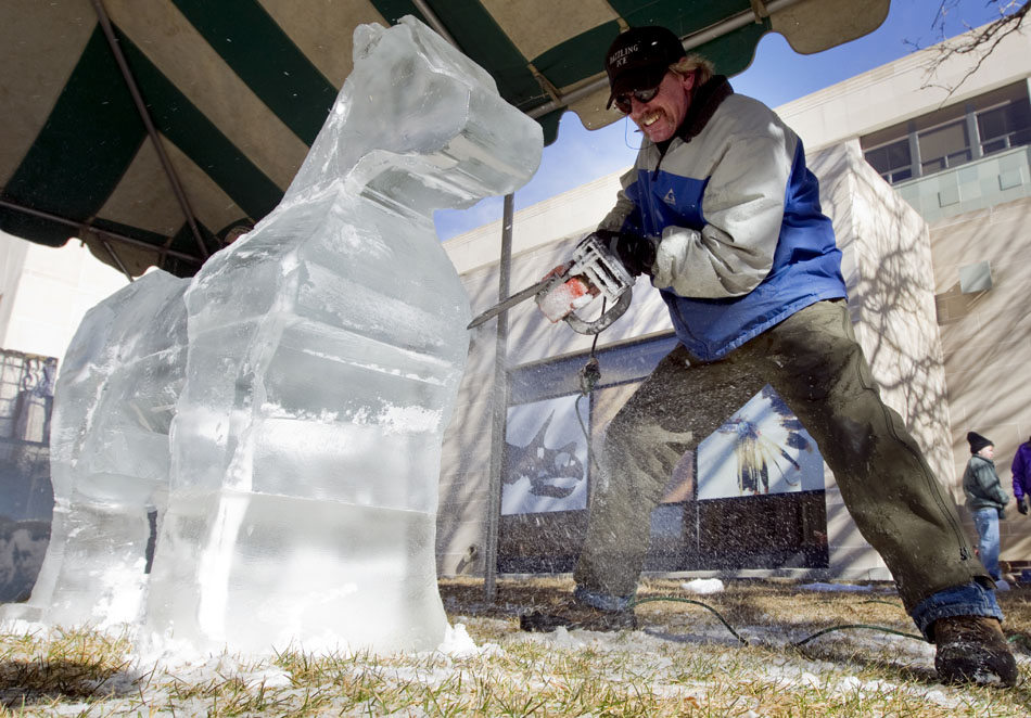 Kevin Petty carves a horse out of a block of ice using an electric chain saw during the Xtreme Ice Festival on Saturday, Jan. 22, 2011, in front of the Wyoming State Museum in Cheyenne.
