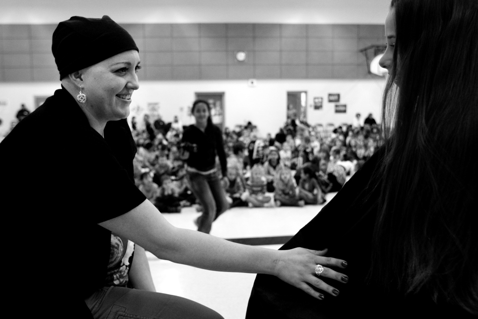 Sunrise Elementary teacher Heather Blakely-Voyles, left, talks with student Jacquelyn Sparks, age 9, as Sparks donates part of her hair to Locks of Love during a student assembly on Friday, Jan. 28, 2011, at the school. Three students donated hair in honor of Blakely-Voyles, who has taken a leave of absence from the school as she battles cancer.