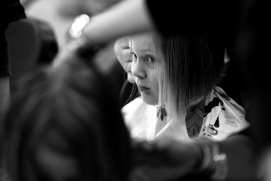 Emma Brekhus, age 7, watches as a fellow student donates hair to Locks of Love on Friday, Jan. 28, 2011, at Sunrise Elementary.