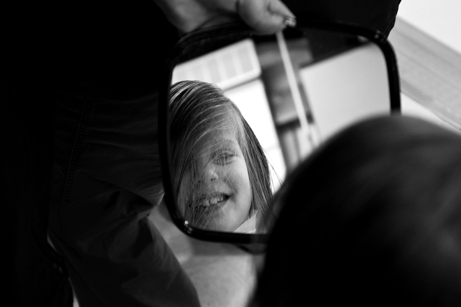 Emma Brekhus, age 7, checks out her new hair do after donating a large lock of hair to Locks of Love on Friday, Jan. 28, 2011, at Sunrise Elementary. Three students donated hair in honor of second grade teacher Heather Blakely-Voyles, who has taken a leave of absence from the school as she battles cancer.