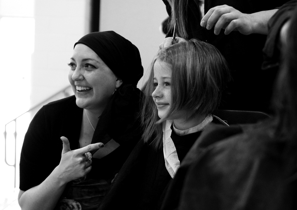 Sunrise Elementary teacher Heather Blakely-Voyles, left, poses for a photo with student Avery Bott, age 9, as Bott donates hair to Locks of Love on Friday, Jan. 28, 2011, at the school. The students donated hair in honor of Blakely-Voyles, who is undergoing treatments for cancer.