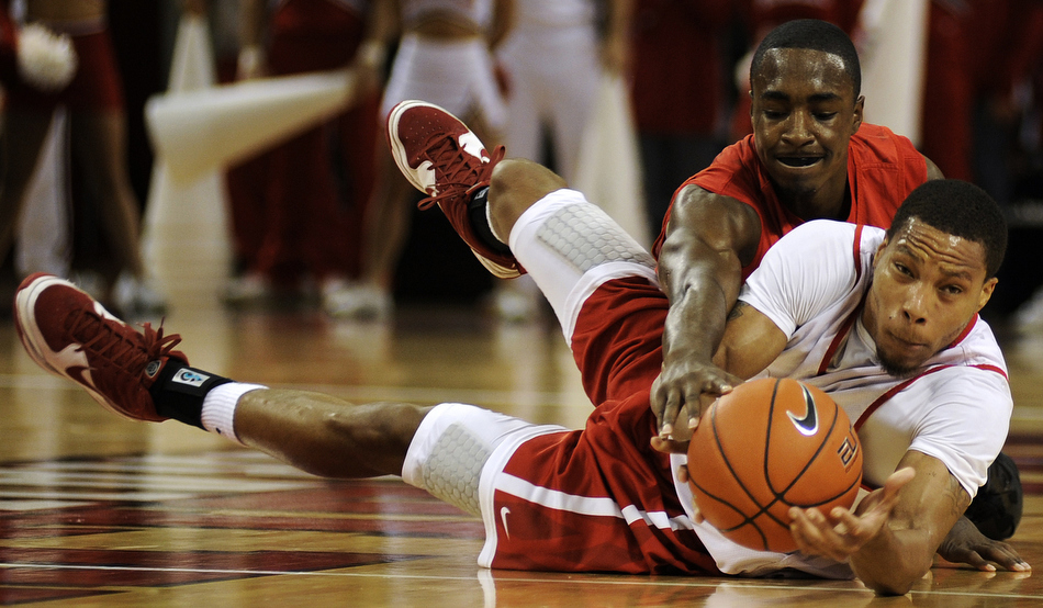 Bradley's Dyricus Simms-Edwards tries to flip the ball to a teammate as Charonn Woods wrestles for the ball during the red and white team scrimmage on Sunday, Oct. 24, 2010, at the Renaissance Coliseum in Peoria, Ill.