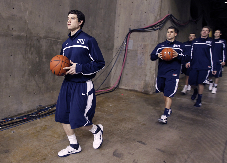 BYU guard Jimmer Fredette, left, leads the team onto the court before a game against Wyoming on Tuesday, Feb. 2, 2011, in Laramie, Wyo.