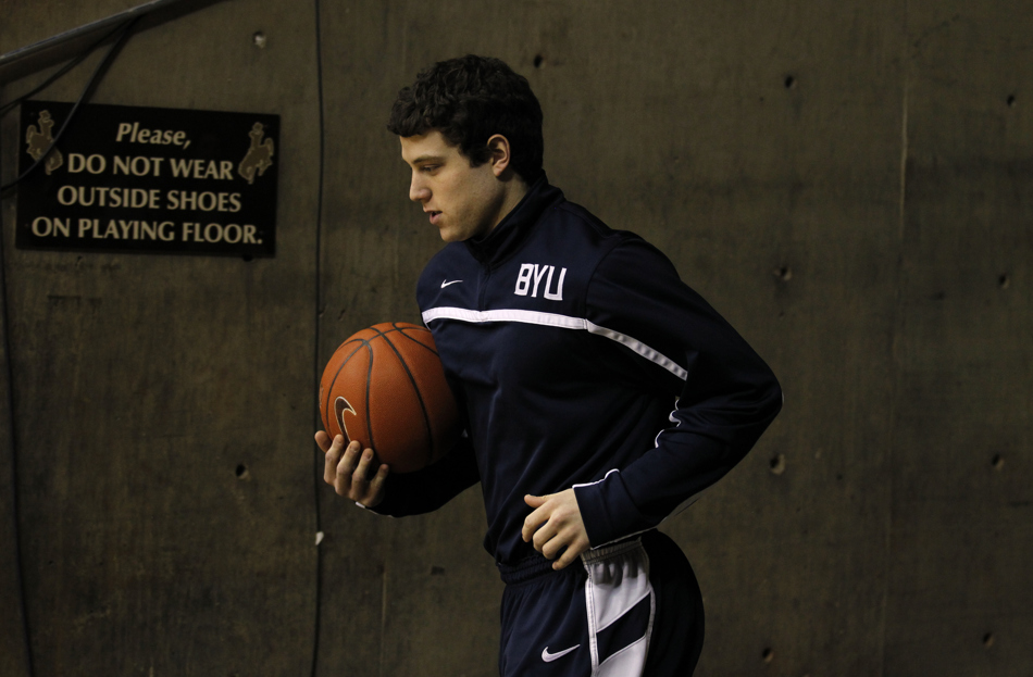 BYU guard Jimmer Fredette, left, leads the team onto the court before a game against Wyoming on Tuesday, Feb. 2, 2011, in Laramie, Wyo.
