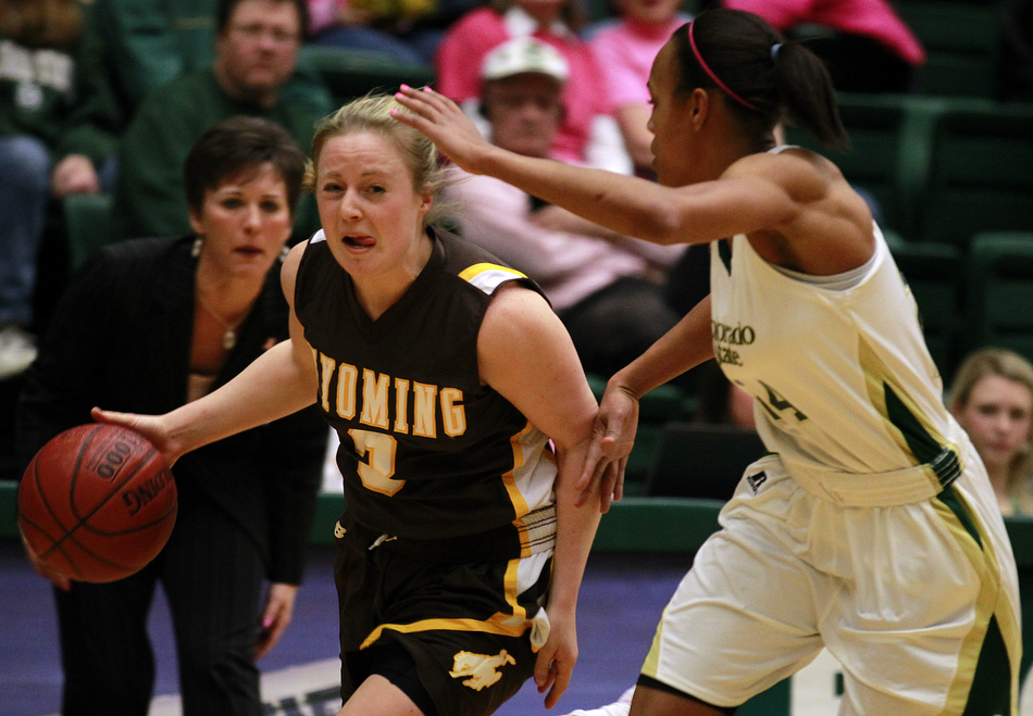 Wyoming guard Randi Richardson (3) takes the ball down the court as she's guarded by Colorado State guard Chantel Kennedy (24) during a game on Saturday, Feb. 5, 2011, in Fort Collins. 