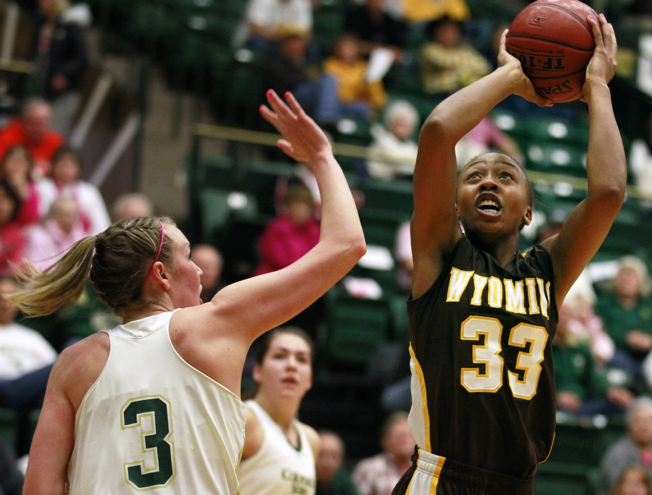 Wyoming forward Chaundra Sewell (33) puts up a shot over Colorado State guard Hayley Thompson (3) during a game on Saturday, Feb. 5, 2011, in Fort Collins.
