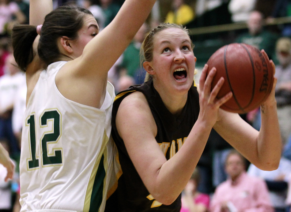 Wyoming forward Hillary Carlson, right, looks to put up a shot from the post as she's guarded by Colorado State forward Sam Martin (12) during a game on Saturday, Feb. 5, 2011, in Fort Collins.