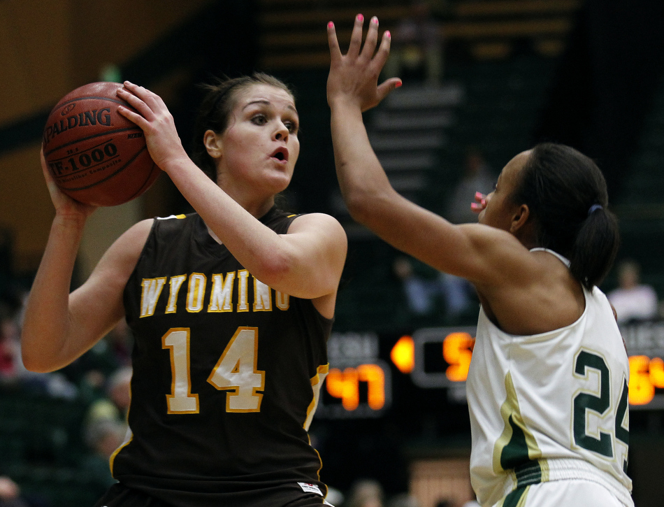 Wyoming forward Jade Kennedy (14) looks to pass as she's guarded by Colorado State guard Chantel Kennedy (24) during a game on Saturday, Feb. 5, 2011, in Fort Collins.