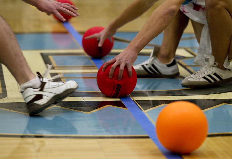 Players grab for the balls at the beginning of a game during a charity dodgeball tournament on Tuesday, Feb. 8, 2011, at East High School. The tournament benefited the Denver  Children's Miracle Network.