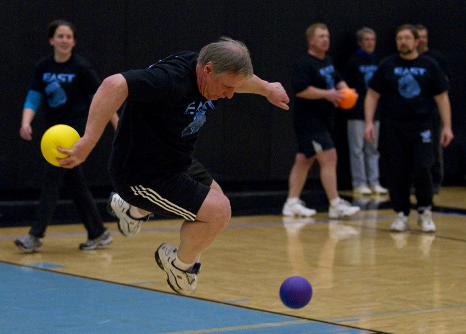 Bill Strong jumps to avoid a ball during a charity dodgeball tournament on Tuesday, Feb. 8, 2011, at East High School. The tournament benefited the Denver Children's Miracle Network.
