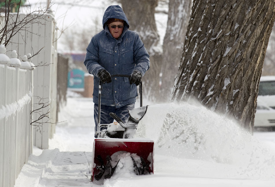 A man who would only give his first name, Allen, clears a sidewalk on Tuesday, Feb. 8, 2011, along Maxwell Avenue at the intersection with 18th Street. The man said he had cleared several of his neighbor's sidewalks after a winter storm dumped several inches of snow on Cheyenne late Monday and in the morning on Tuesday.