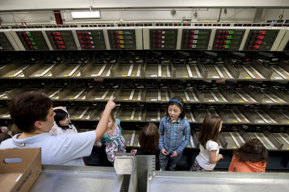 Lynette Tafoya, left, a clerk at the Cheyenne U.S. Post Office, shows an automated mail sorting machine to youngsters as she gives a tour of the Converse Avenue facility to more than 30 first graders from Buffalo Ridge Elementary on Wednesday, Feb. 9, 2011, in Cheyenne.