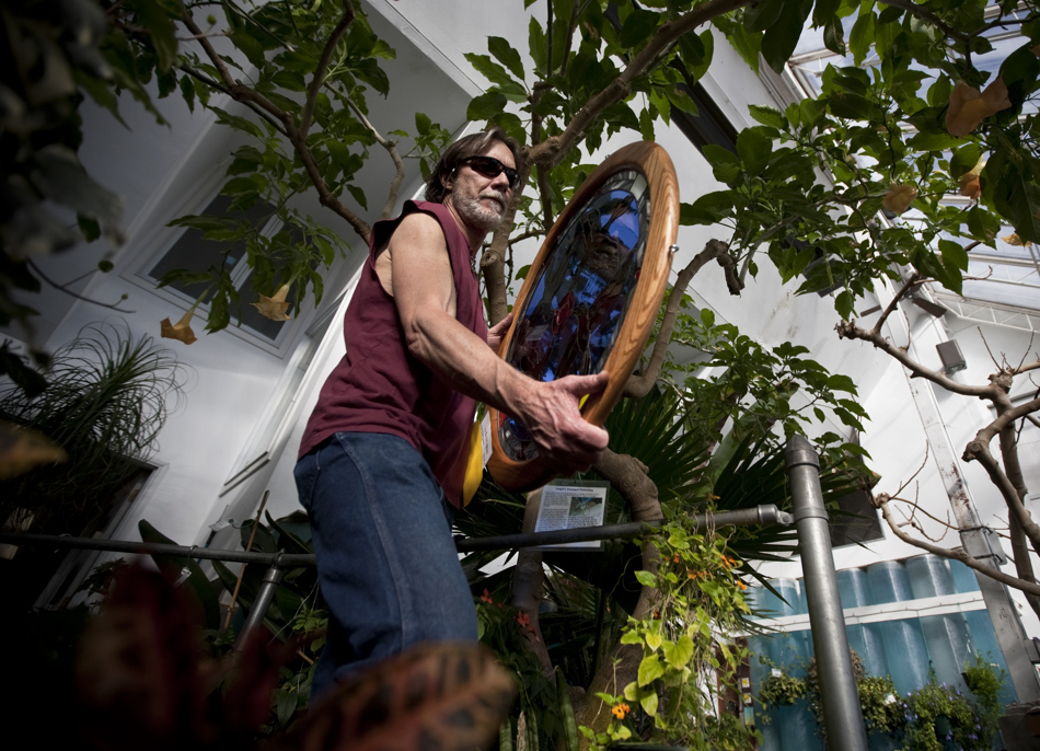 Craig McCune carries a piece of glass artwork titled "Raven's Quest" into the greenhouse to be hanged for showing in the US Bank Glass Art Celebration on Thursday, Feb. 10, 2011, at the Cheyenne Botanic Gardens. The show, which is in its 30th year, runs through Feb. 20.