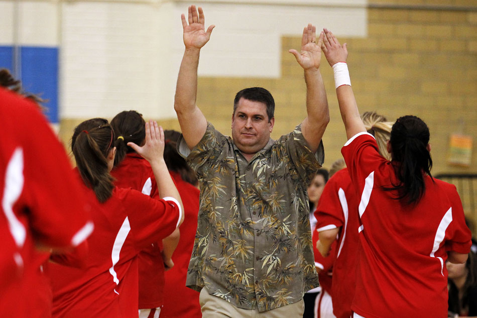 Central coach Chad Whitworth high fives his players as they run off the court following pre-game warm ups before a game against East on Saturday, Feb. 12, 2011, at Storey Gym in Cheyenne. Central won 59-51.