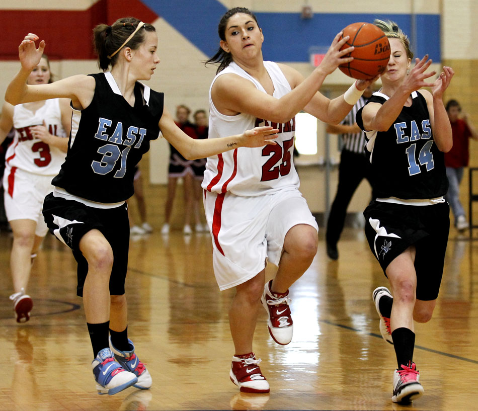 Central's Raven St. Clair (25) looks to pass on a fast break as she's guarded by East's Rachel Erickson (31) and Anna Reiner (14) during a game on Saturday, Feb. 12, 2011, at Storey Gym in Cheyenne. Central won 59-51.