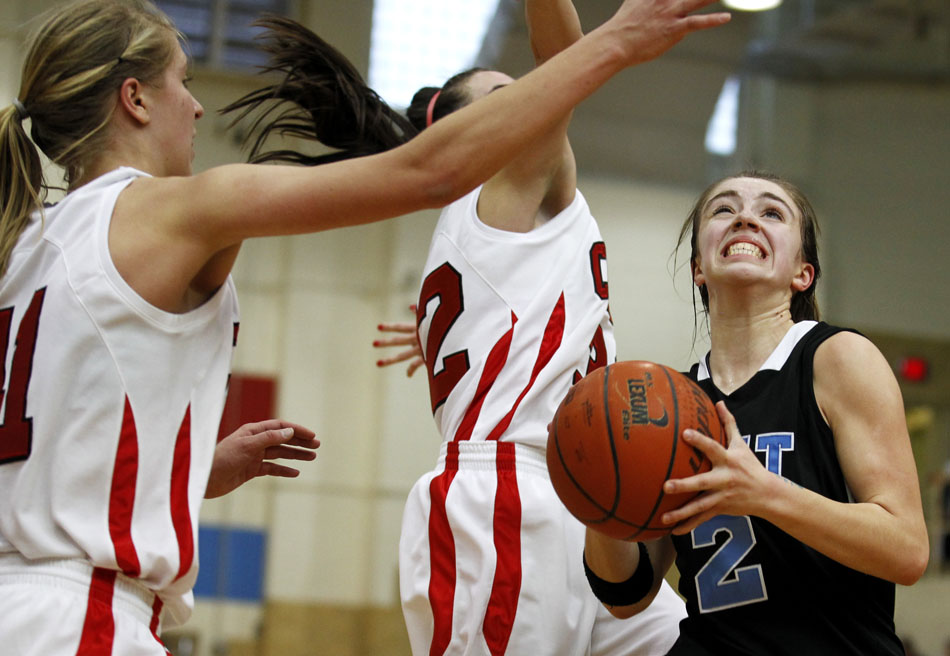 East's Savannah Minder, right, reacts as she goes in for a lay up as she's guarded by Central's Christie Schiel, left, and Makena Cameron during a game on Saturday, Feb. 12, 2011, at Storey Gym in Cheyenne. Central won 59-51.