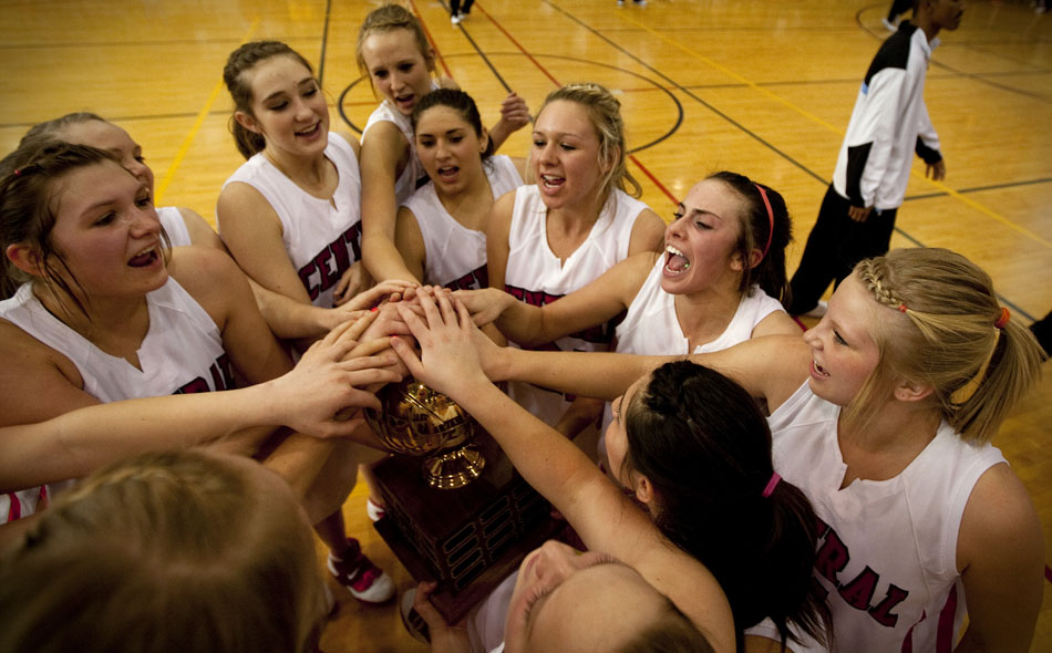 Central players celebrate with the trophy after defeating cross-town rival East in the second of two meetings this season on Saturday, Feb. 12, 2011, at Storey Gym in Cheyenne.