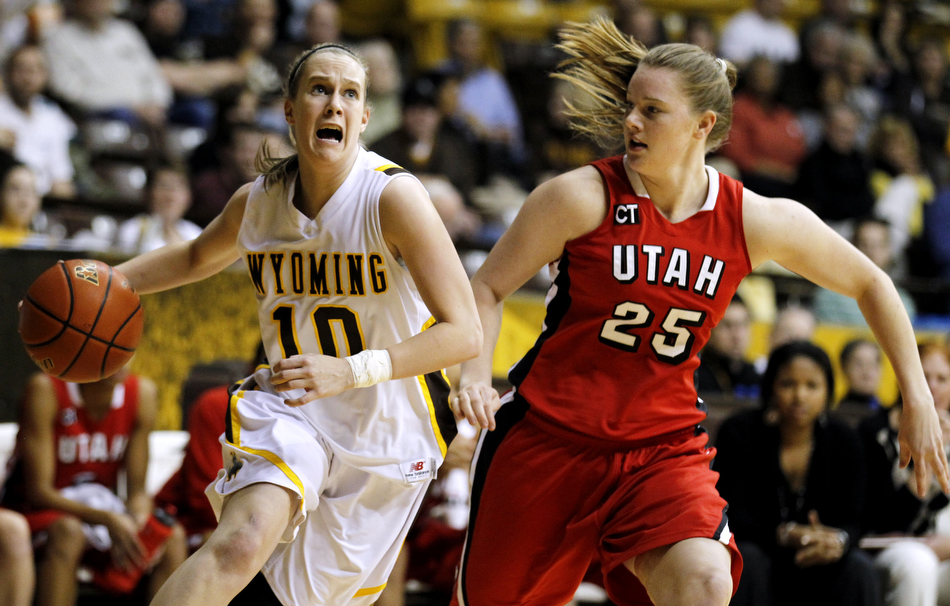 Wyoming guard Bec Campigli (10) drives to the basket in front of Utah guard Allison Gida (25) during a game on Wednesday, Feb. 16, 2011, in Laramie, Wyo.