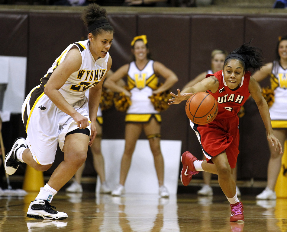 Utah guard Iwalani Rodrigues (3) locates a loose ball as Wyoming guard Aubrey Vandiver (20) looks to force a turnover during a game on Wednesday, Feb. 16, 2011, in Laramie, Wyo.