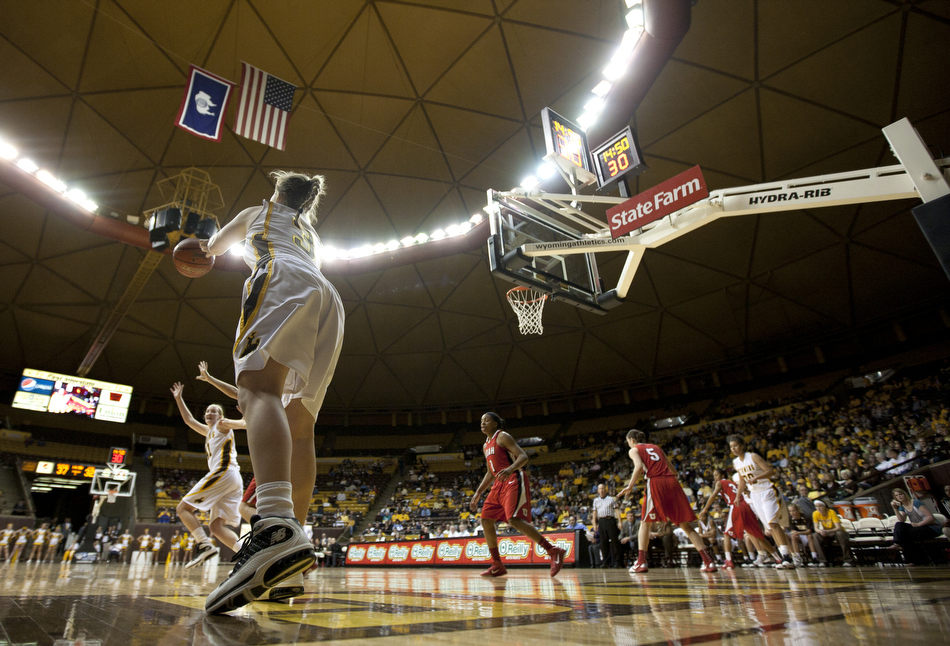 Wyoming guard Randi Richardson (3) inbounds the ball to teammate Hillary Carlson during a game against Utah on Wednesday, Feb. 16, 2011, in Laramie, Wyo.