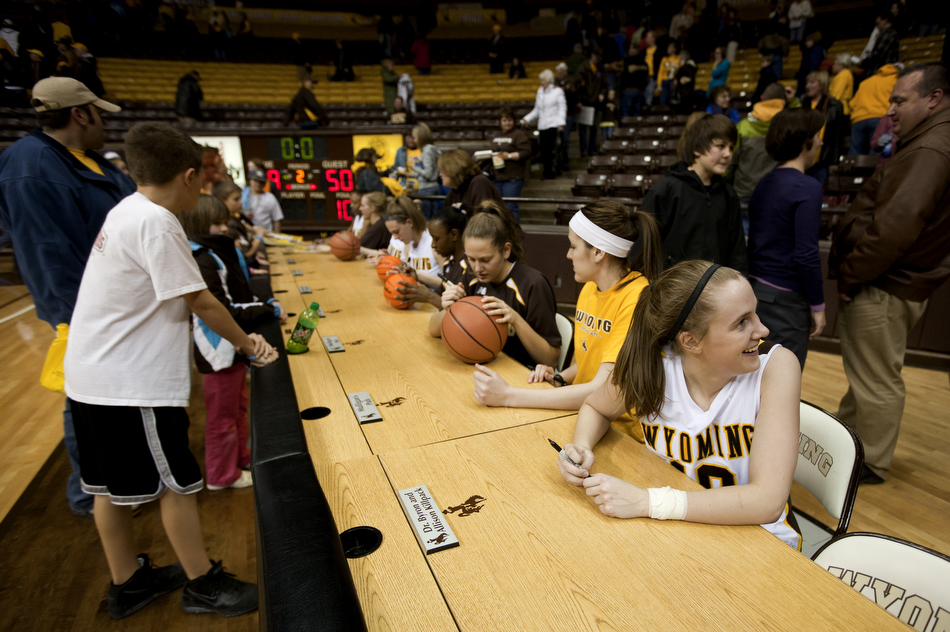 Wyoming guard Bec Campigli, right, talks with a friend after a 59-50 win against Utah on Wednesday, Feb. 16, 2011, in Laramie, Wyo.