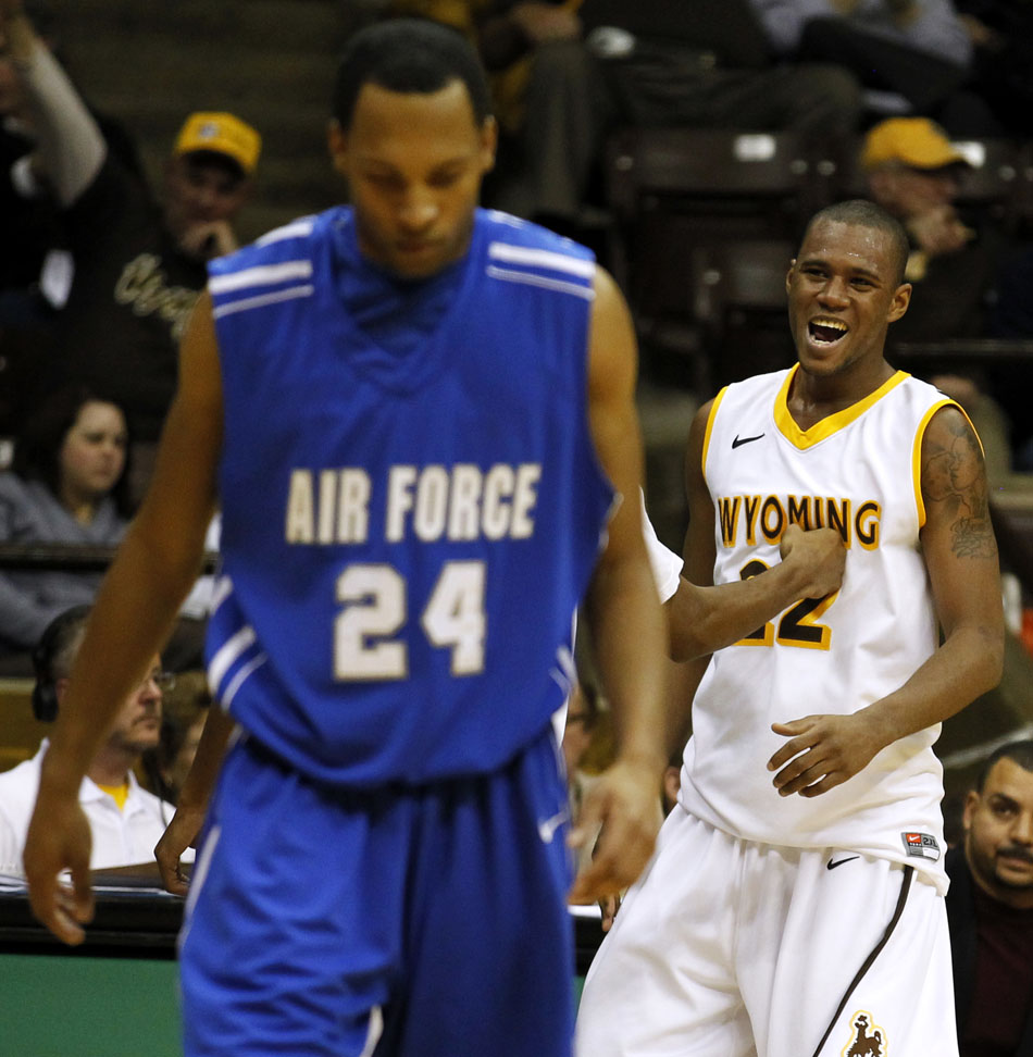 Wyoming forward Amath M'Baye (22) pounds his chest after forcing a turnover as Air Force forward Derek Brooks (24) walks away dejected during a NCAA men's basketball game on Wednesday, Feb. 23, 2011, in Laramie, Wyo.