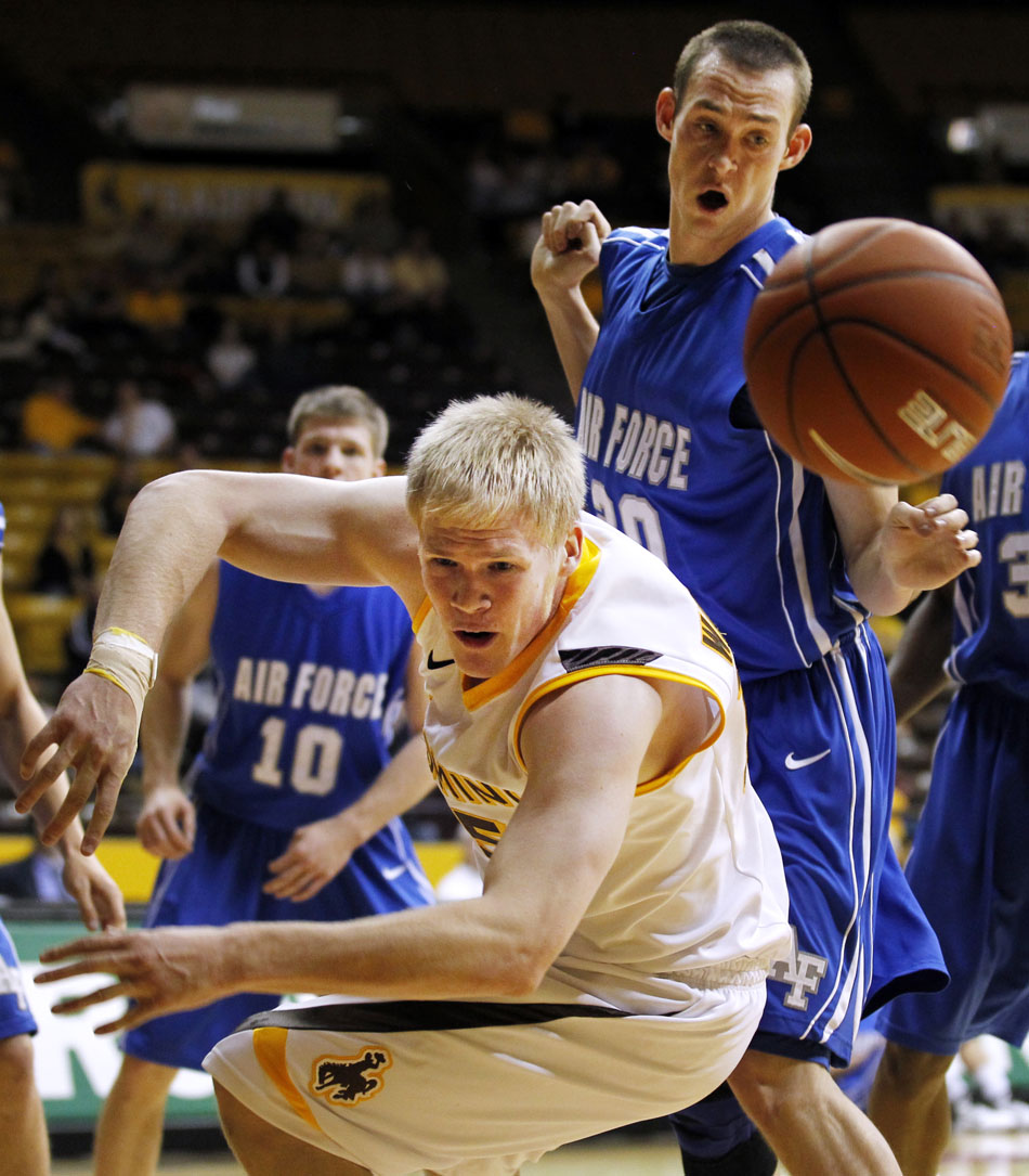 Wyoming center Adam Waddell watches as the ball flies out of bounds after it was knocked away by Air Force forward Adam Brakeville during a NCAA men's basketball game on Wednesday, Feb. 23, 2011, in Laramie, Wyo.