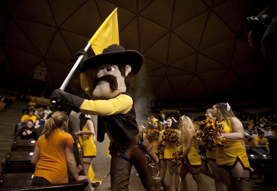 Wyoming mascot Pistol Pete runs the team flag onto the court as the men's basketball team prepares to run out of the tunnel for a game against Air Force on Wednesday, Feb. 23, 2011, in Laramie, Wyo.