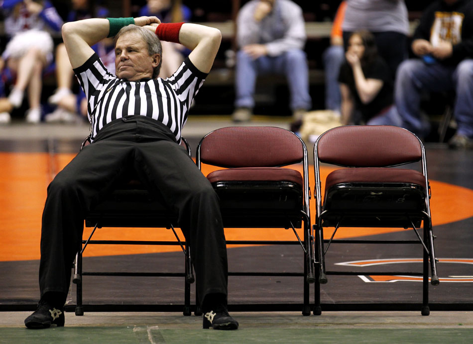 A referee takes a break between matches at the Wyoming state wresting semi-finals on Friday, Feb. 25, 2011, in Casper, Wyo.