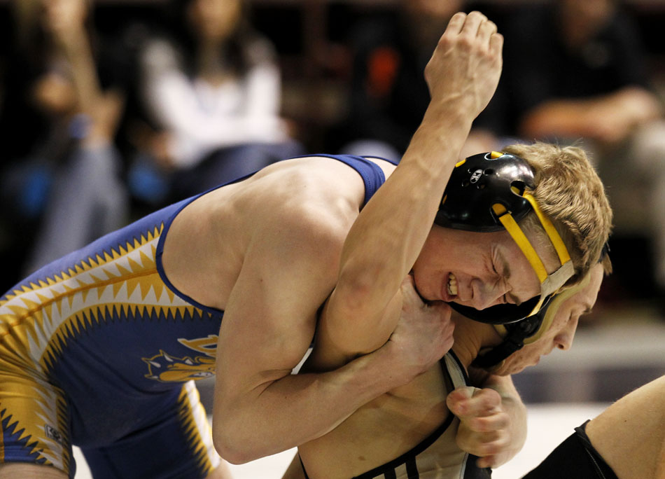 Wheatland's Chaz McAuley, left, reacts as he struggles to put a move on Cheyenne South's Erik Fair during a wrestleback match on Friday, Feb. 25, 2011, in Casper, Wyo.